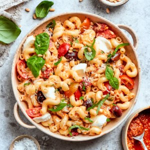 a salad bowl of sun dried tomato pasta salad