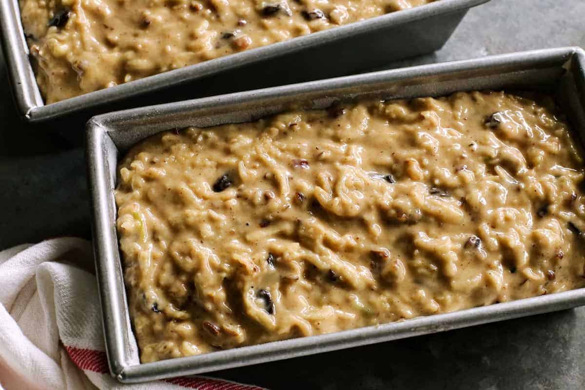 batter for apple bread in two loaf pans