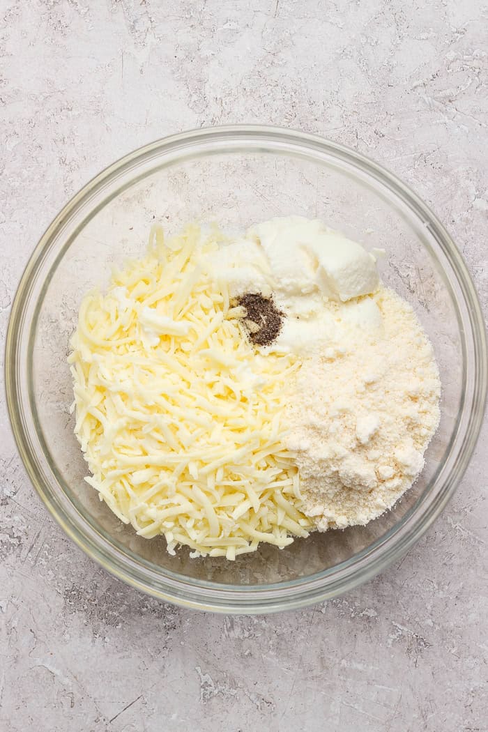 ingredients to make cheesy yum, in a clear bowl