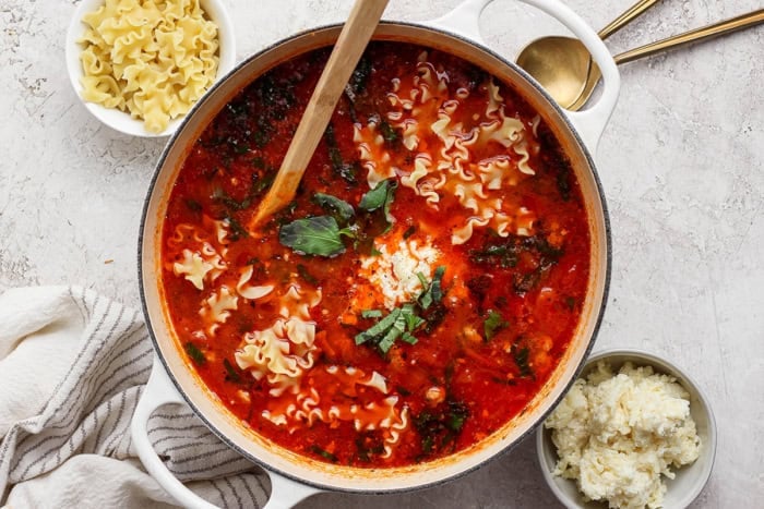 a large white pot of finished lasagna soup, with cheesy yum, mafalda noodles, and cheesy yum