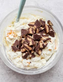 chopped Fudge Stripe Cookies on top of the cookie salad in a large clear bowl