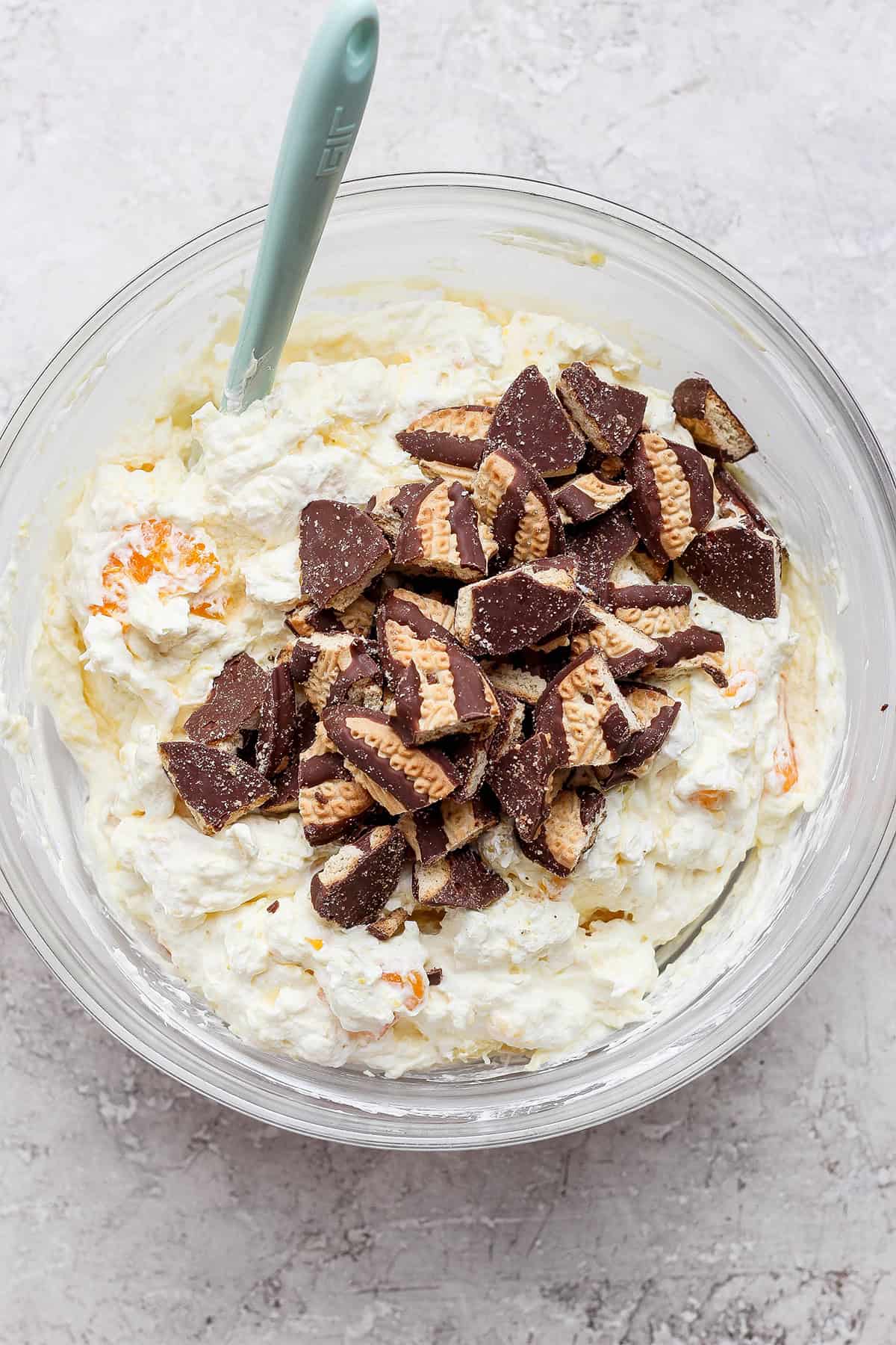 chopped Fudge Stripe Cookies on top of the cookie salad in a large clear bowl